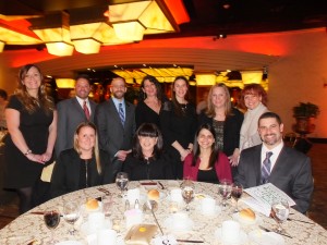 HCT honorees Diana Germinario (standing center) and Corinne Pope (seated 2nd from right) celebrate the evening with family, colleagues and friends.